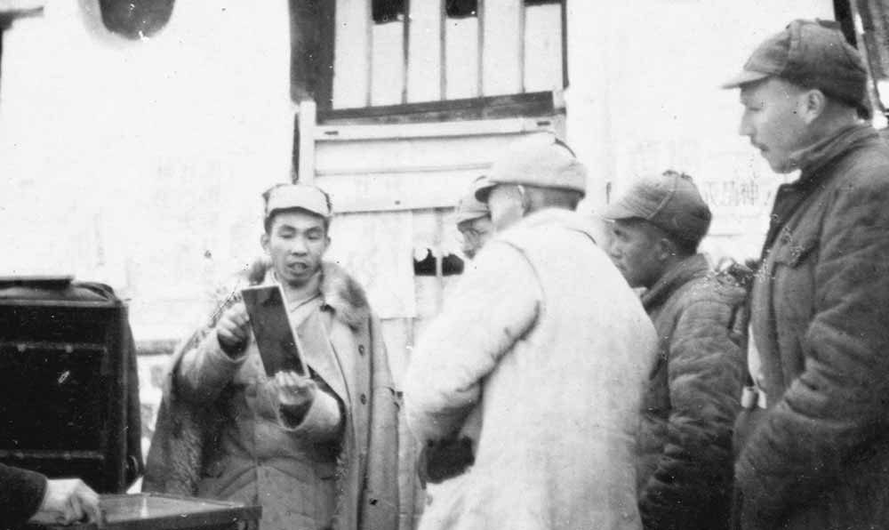 沙飛向參觀者講《晉察冀畫報》的制版情況。